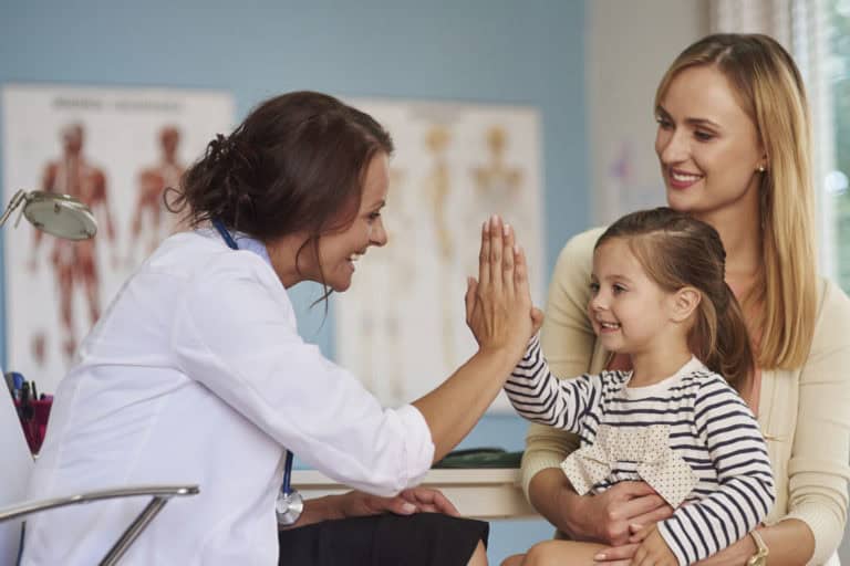 Woman and daughter with doctor